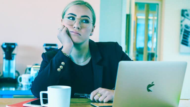woman thinking with computer