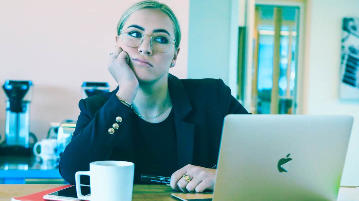 woman thinking with computer